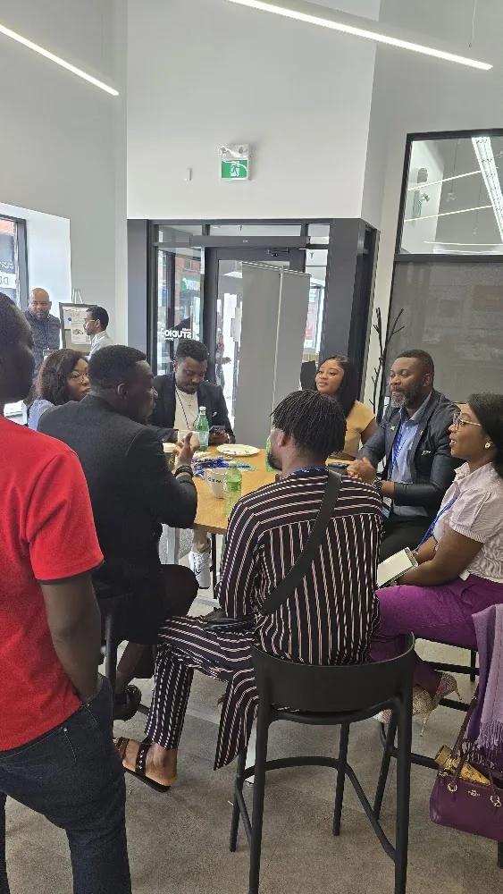 Participants networking in small groups after the July CI3 program
